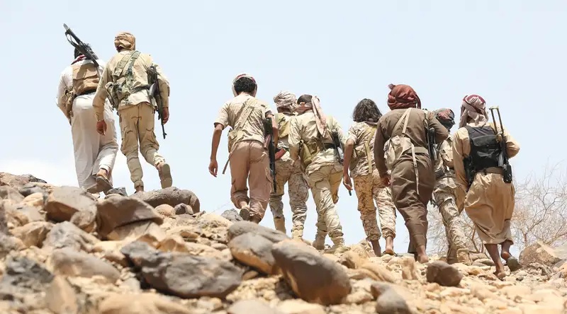 Members and officers of the army forces at a site south of Marib