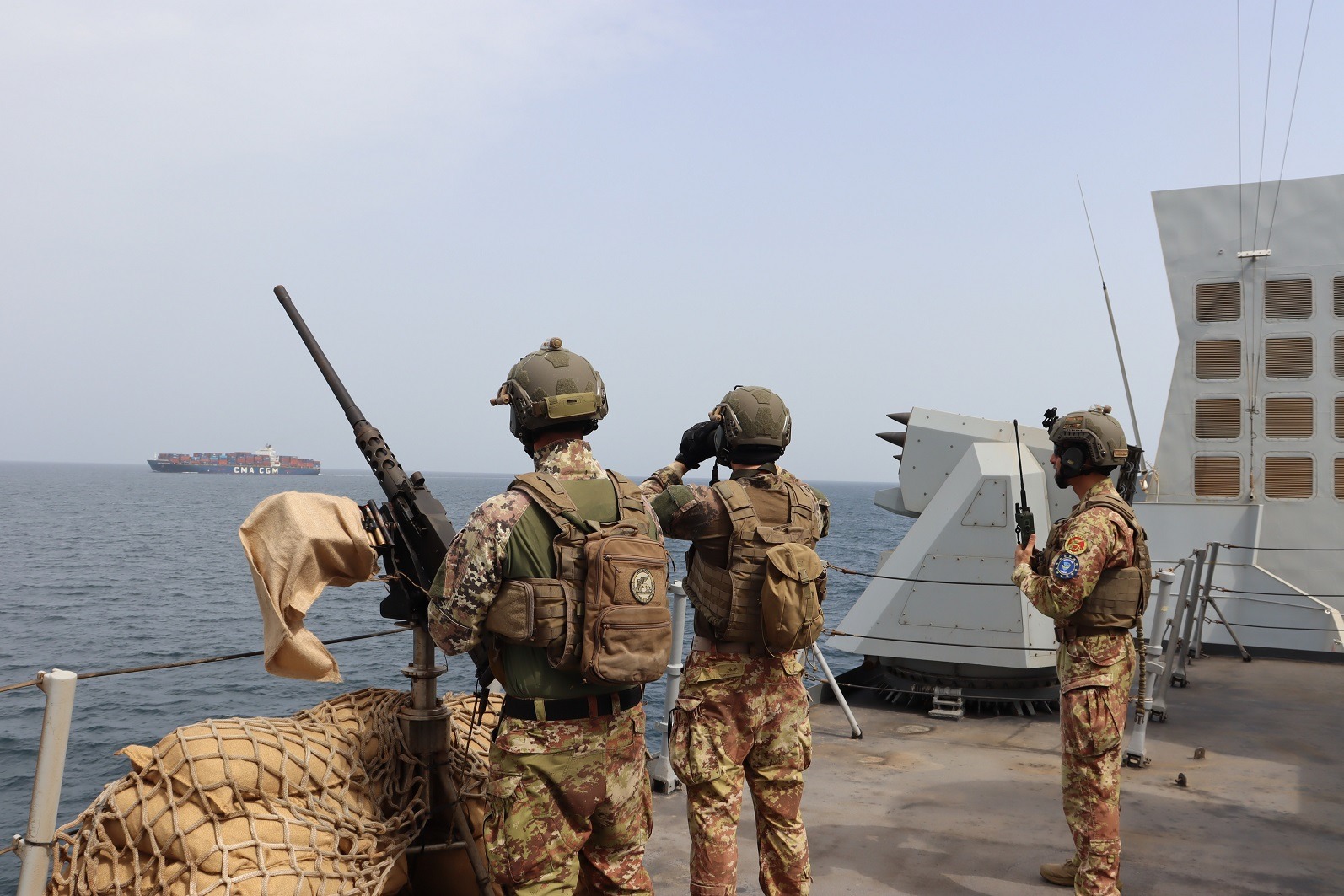 Soldiers on a naval asset protect a merchant vessel (Aspidis).